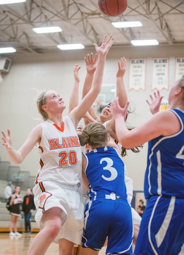 Mikayla Deming, l., gets the rebound in a home game against  Sedro-Woolley January 8. Blaine won the NWC game 65–43. Photo by Janell Kortlever